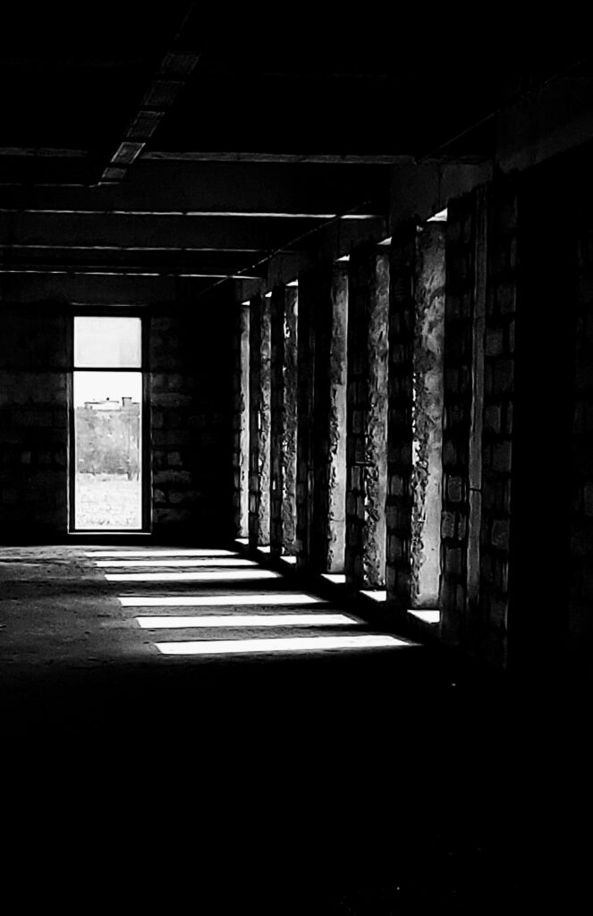 Light streams through an under construction building's windows.